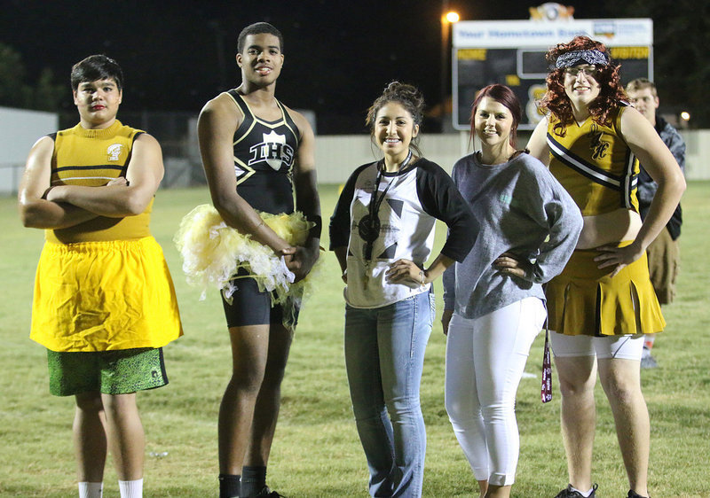 Image: Making some noise were Powder Puff cheerleaders Nick “Nicky” Kirton, Christian “Christina” Lightfoot and Michael “Michelle” Hughes who pose with their cheer coaches Lizzy Garcia and Brooke DeBorde.