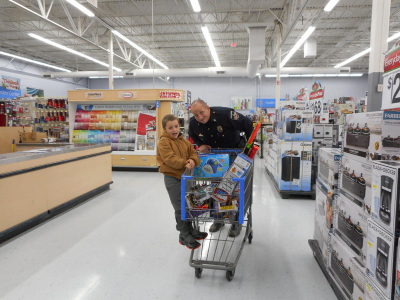 Image: Chief Beckham helps one of the students shop for his family.
