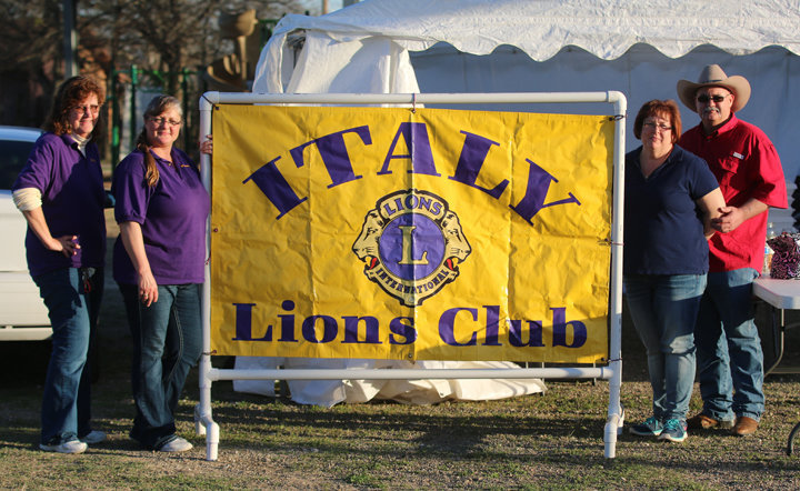 Image: Italy Lions Club members Meg Lyons, and Flossie Gowin, along with fellow members Karen and Donald Brummett pose with the Italy Lion Club banner after as the 2017 BBQ Cook-off comes to a successful end.