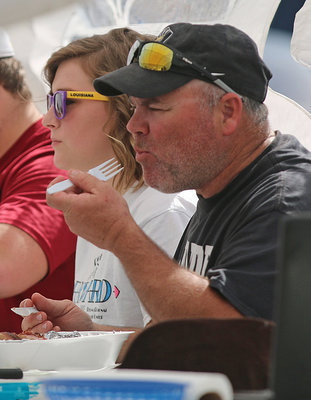 Image: J.D. Jackie Cate, who is currently campaigning to be the next Mayor of Italy, helps judge the brisket competition by voting for his favorites. Remember to Vote May 6th in our city election.