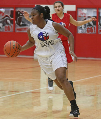 Image: Italy’s Aarion Copeland pushes the ball up the court to hel;p lead the WHITE squad to victory during the running of the 16th Annual Maypearl Texas Roundup Girls All-Star game.