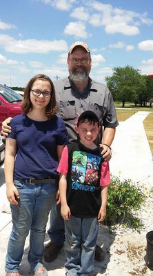 Image: Jonathan Soukup and his children, Mollie and Jack, delivered the shrubs that Southwest Perennials donated. They stayed and helped with the planting.