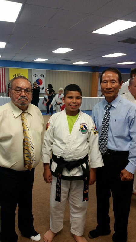Image: Pictured is Master Charles Kight chief instructor of the school, Nick and Grand Master BK Park co-founder of Unified Tae Kwon Do School.