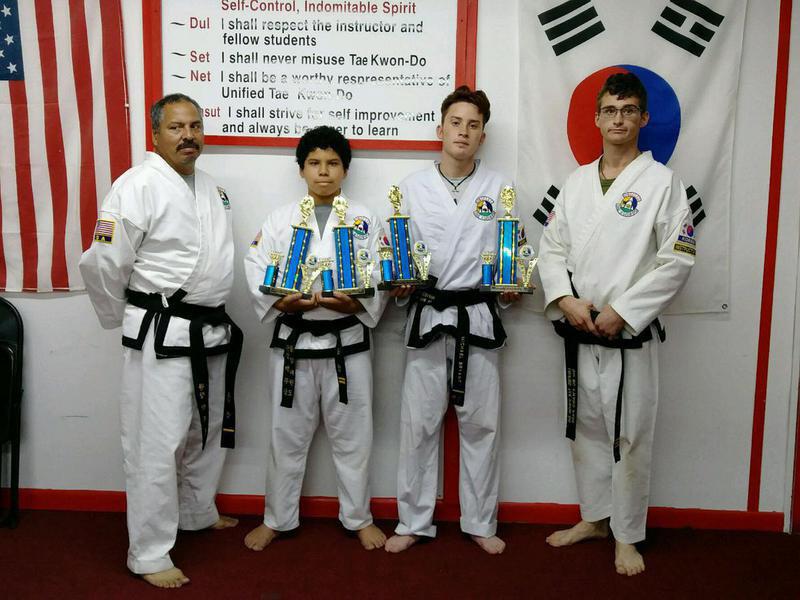 Image: Pictured Roger Sam, Instructor, Nick Sam, 2nd Degree Black Belt, Michael Bryant, 1st Degree Black Belt and Travis Tinney Instructor