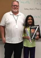 Image: Mr Graves, 5th grade music teacher; Itzy; and her prize winnings, including a new recorder and a book of “Star Wars” tunes for the recorder.
